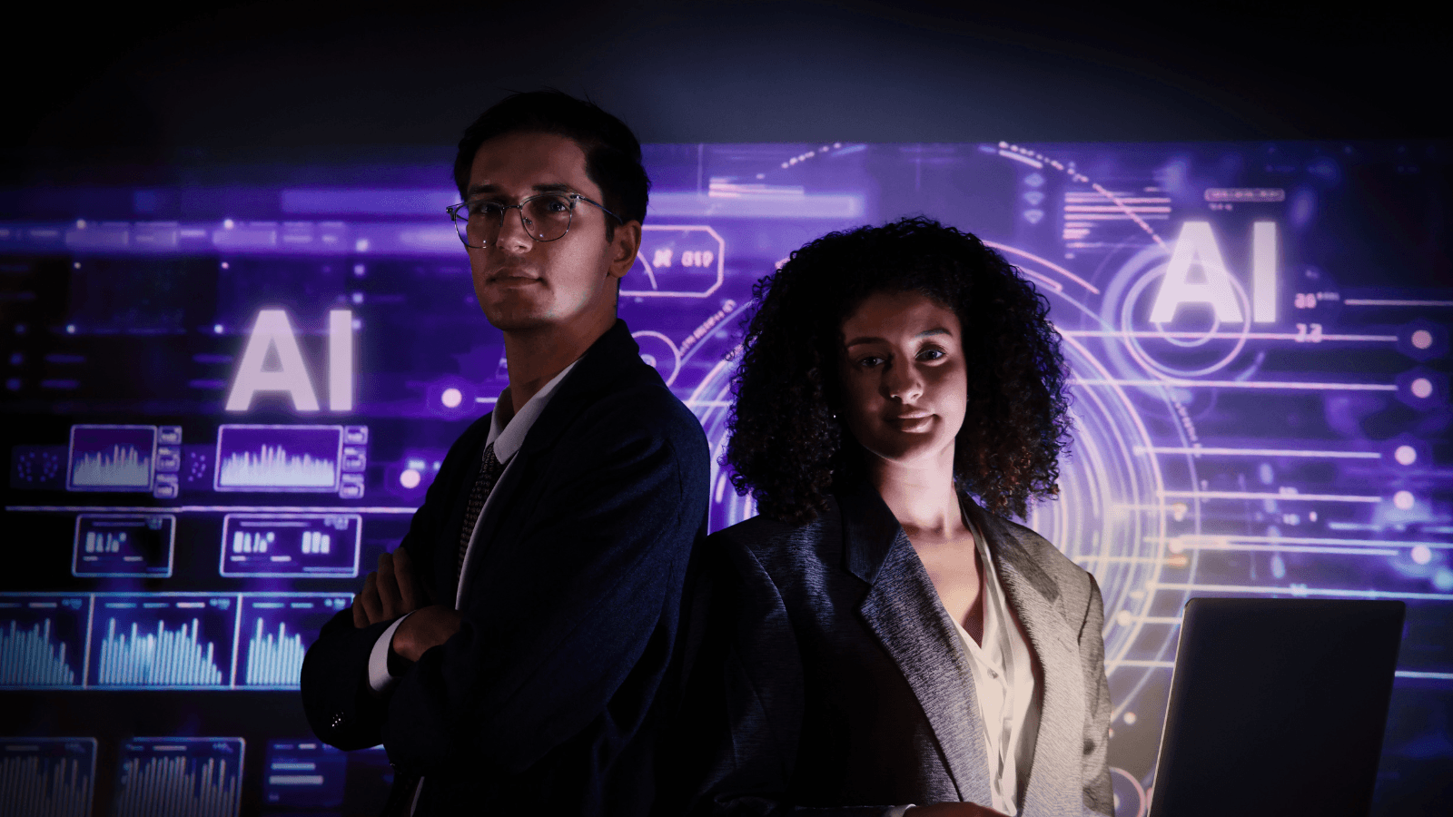 Two young professionals — a certification cohort — in front of an AI governance dashboard